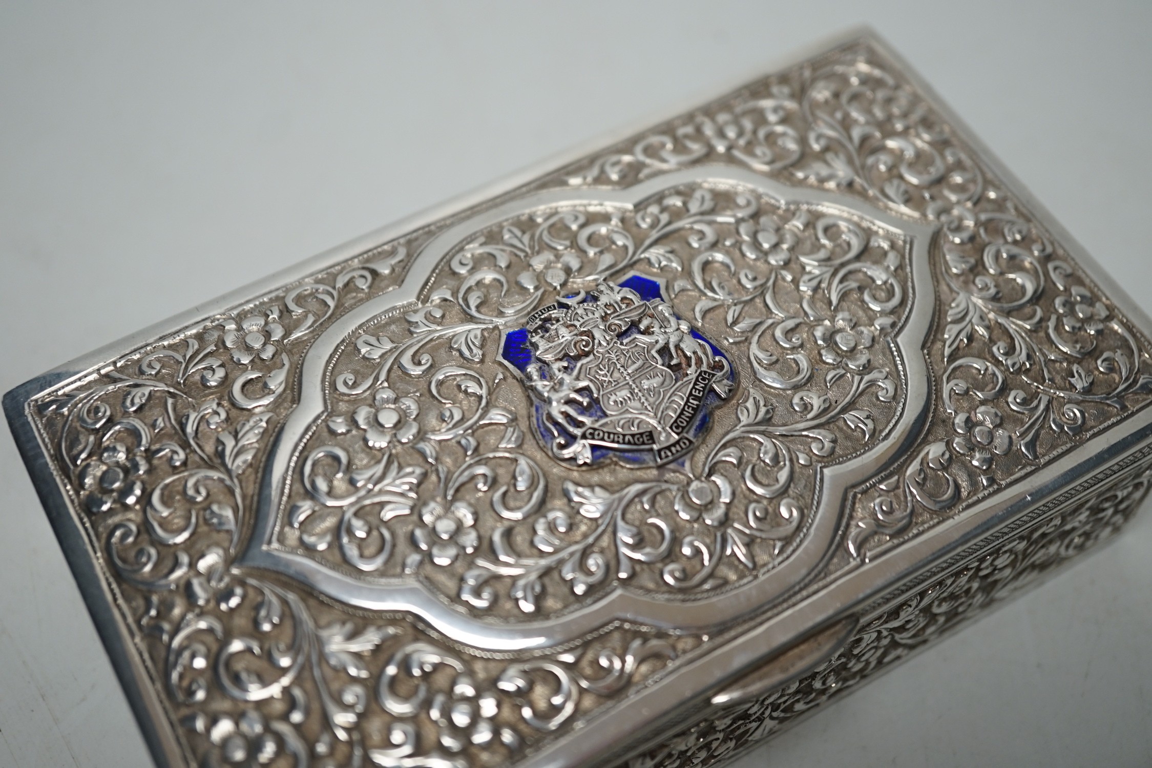 Two early 20th century Indian embossed white metal rectangular boxes, both applied with the enamelled rest of the Bhuj Kutch Gujarat, largest 14.2cm